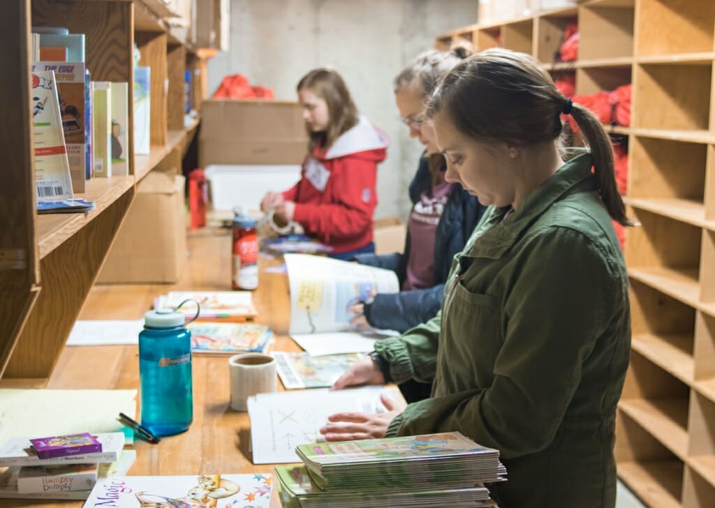 Students assembling printed materials.
