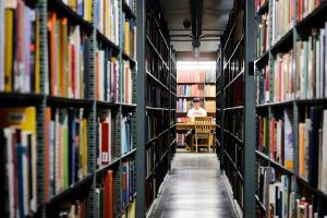 Student studying in the memorial library stacks.