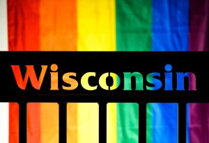 Rainbow flag behind "Wisconsin."
