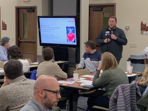 Staff member presenting to a group of staff members.